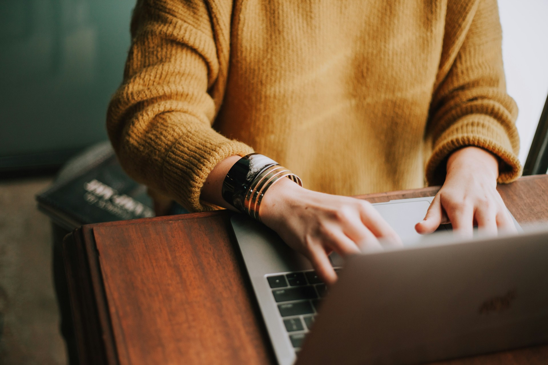 A woman writing a punchy op-ed on a laptop computer
